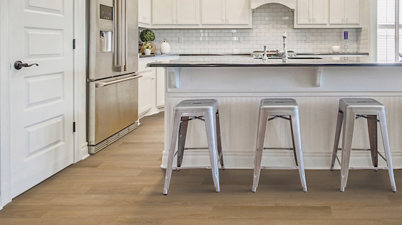 wood look waterproof luxury vinyl flooring in a bright kitchen
